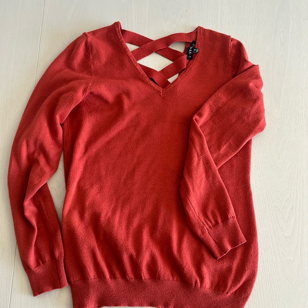 Adorable sweater with open x in back